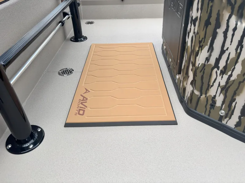 Slide: The Image of Deck of 2025 Avid 20CC Rogue boat with camo design and branded mat. - 3