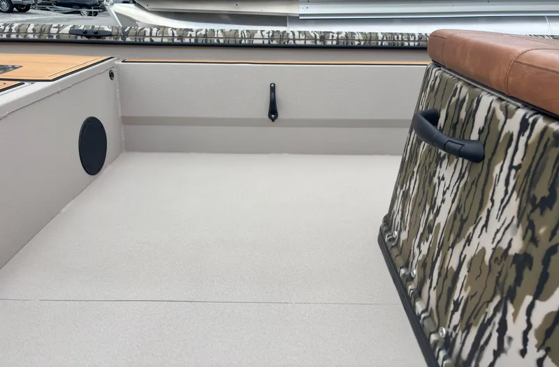 Slide: The Image of 2025 Avid 20CC Rogue boat interior with camo design and seating. - 6