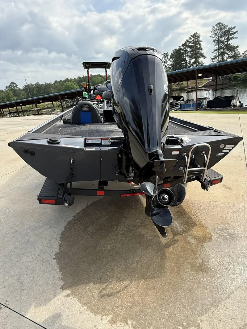 Slide: The Image of 2022 Ranger RT178 boat with outboard motor, parked on concrete near a lake. - 18