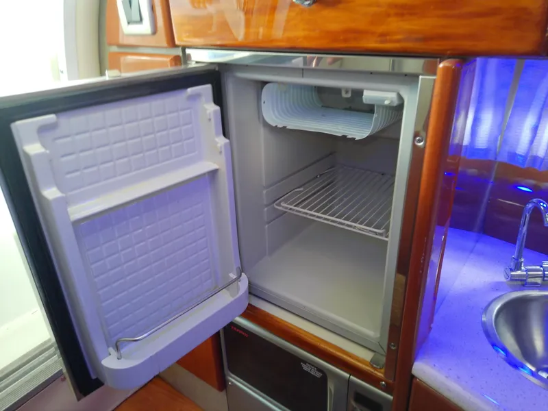 Slide: The Image of 2008 Formula 310 Sun Sport boat interior with open mini fridge and sink. - 36