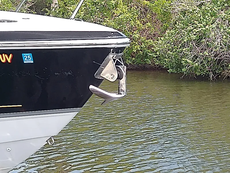 Slide: The Image of 2008 Formula 310 Sun Sport boat anchored on calm water near lush greenery. - 3