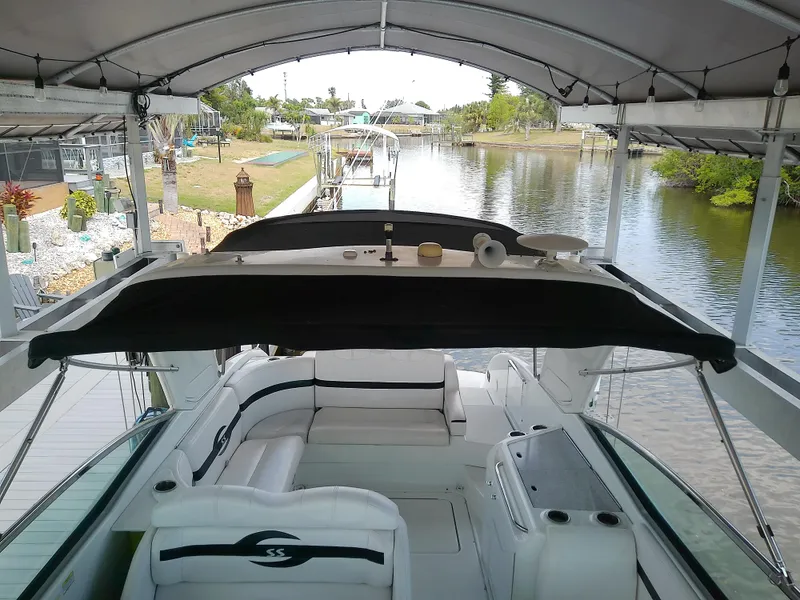 Slide: The Image of 2008 Formula 310 Sun Sport boat docked under canopy, overlooking serene waterway. - 28