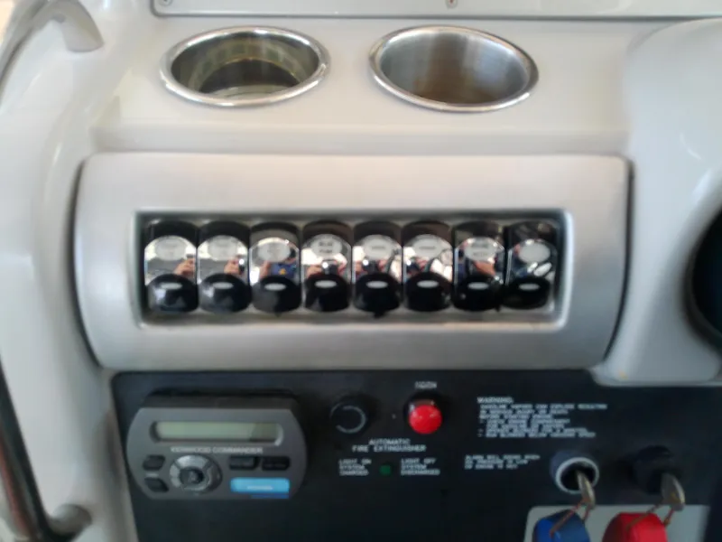 Slide: The Image of Control panel of a 2008 Formula 310 Sun Sport boat with switches and cup holders. - 20