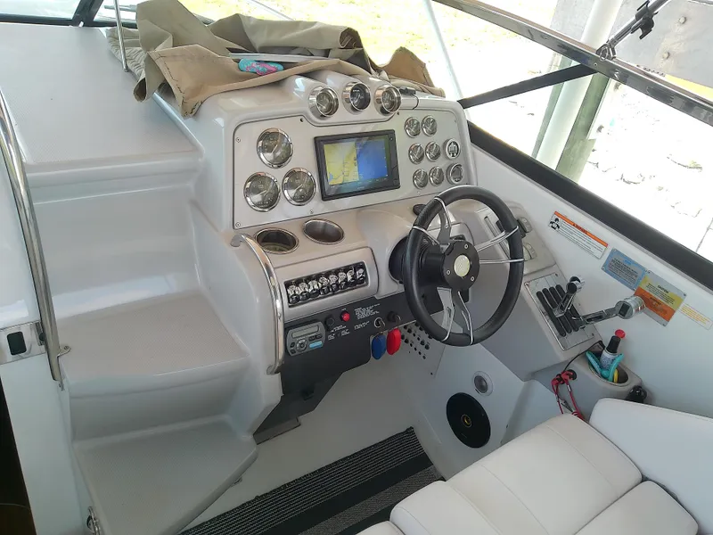 Slide: The Image of 2008 Formula 310 Sun Sport boat cockpit with steering wheel and control panel. - 16