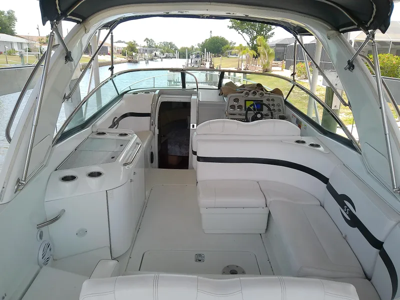 Slide: The Image of 2008 Formula 310 Sun Sport boat interior with white seating and control panel. - 10