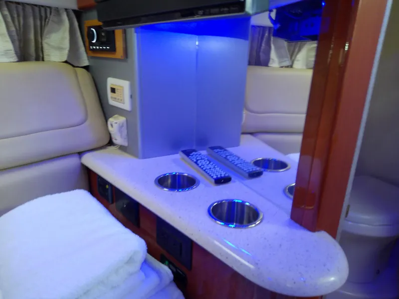 Slide: The Image of 2008 Formula 310 Sun Sport interior with cup holders and blue ambient lighting. - 38