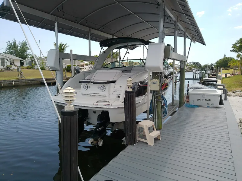 Slide: The Image of 2008 Formula 310 Sun Sport docked under a canopy on a calm waterway. - 4