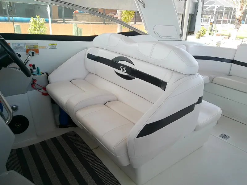 Slide: The Image of 2008 Formula 310 Sun Sport boat interior with white seating and steering wheel. - 13