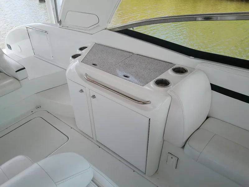 Slide: The Image of 2008 Formula 310 Sun Sport boat interior with white seating and storage area. - 15