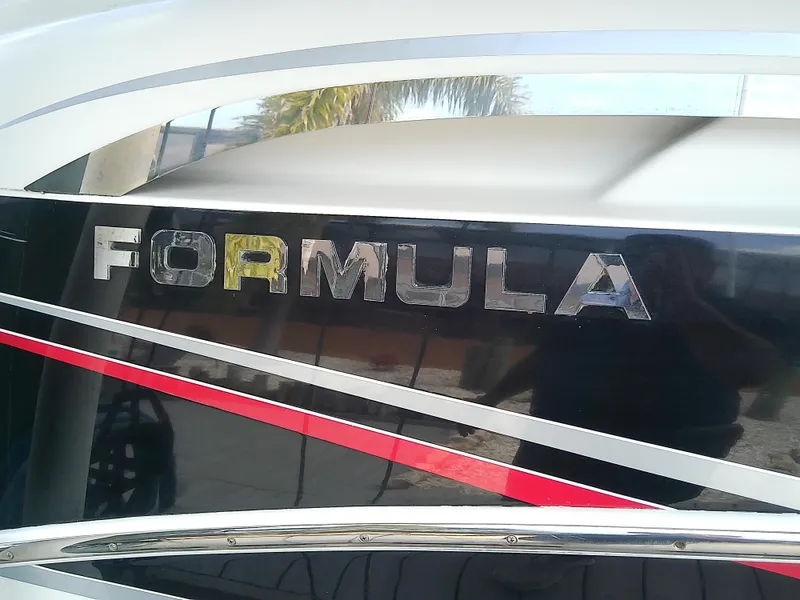 Slide: The Image of 2008 Formula 310 Sun Sport boat with sleek black and red design. - 8