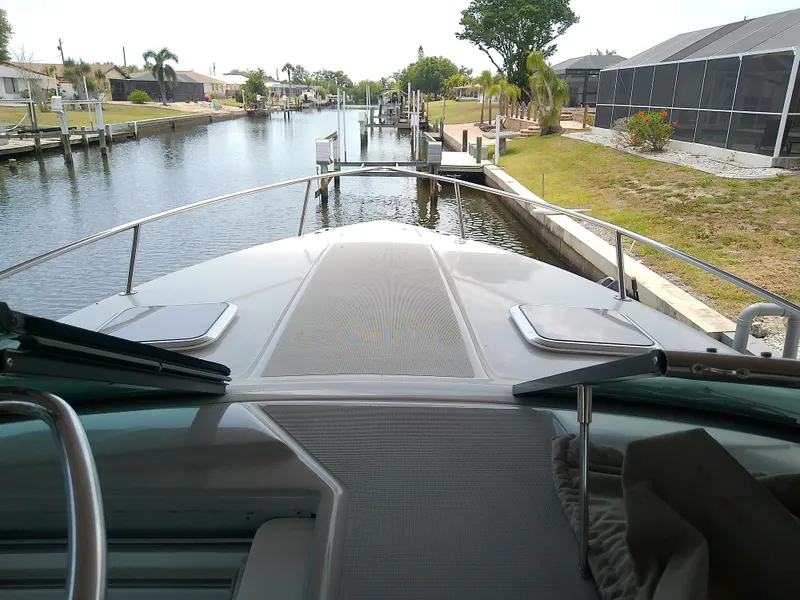 Slide: The Image of 2008 Formula 310 Sun Sport boat docked in a scenic canal setting. - 24