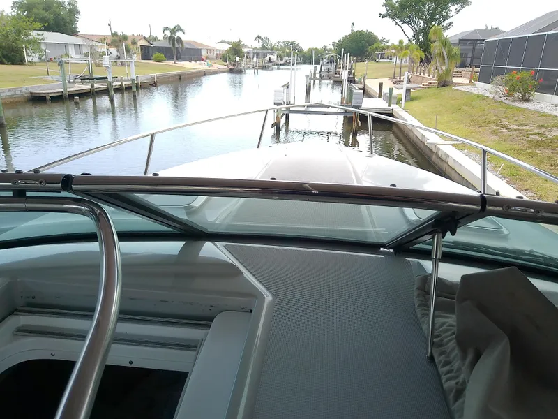 Slide: The Image of 2008 Formula 310 Sun Sport boat docked in a serene canal setting. - 30