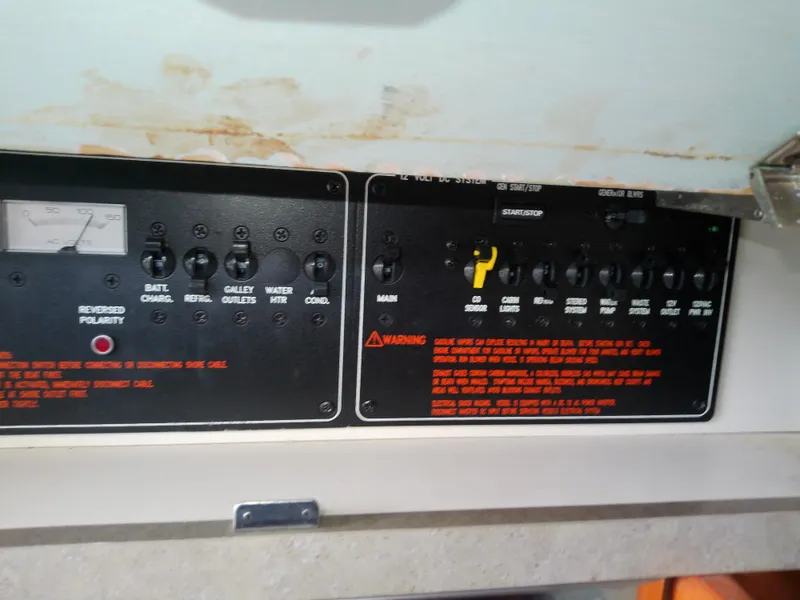 Slide: The Image of Control panel of a 2008 Formula 310 Sun Sport boat with various switches and warnings. - 44