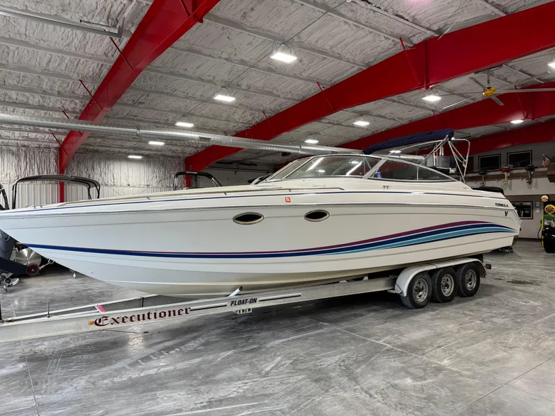 Slide: The Image of 1998 Formula 330 SS boat on trailer in indoor storage facility. - 1
