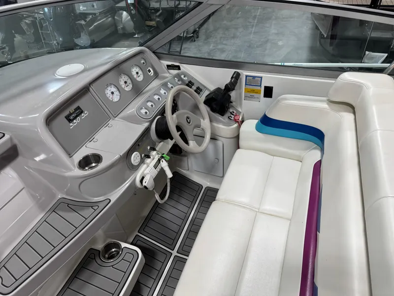 Slide: The Image of 1998 Formula 330 SS boat interior with white seating and modern dashboard controls. - 10