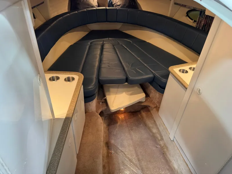 Slide: The Image of 1998 Formula 330 SS boat interior with blue seating and storage cabinets. - 11
