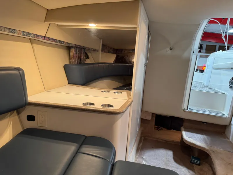 Slide: The Image of Interior of a 1998 Formula 330 SS boat, featuring seating and cabin amenities. - 12