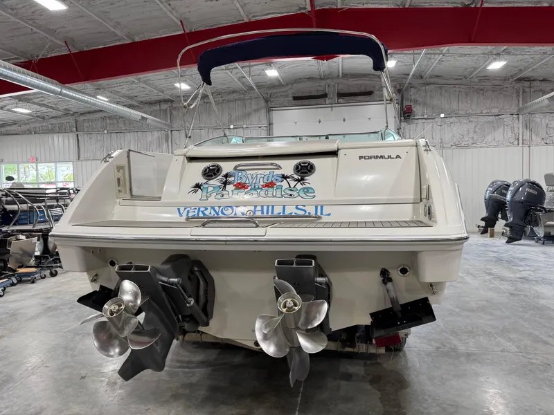 Slide: The Image of 1998 Formula 330 SS boat in a warehouse, featuring dual propellers and custom graphics. - 5
