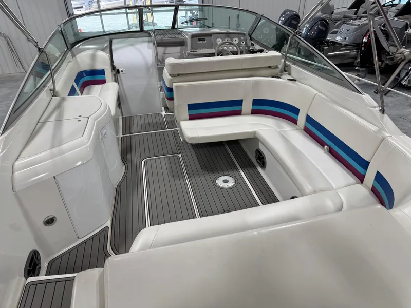 Slide: The Image of 1998 Formula 330 SS boat interior with white seating and colorful accents. - 6