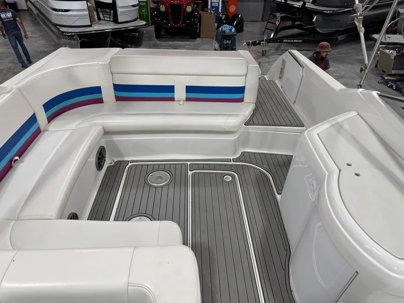 Slide: The Image of 1998 Formula 330 SS boat interior with white seating and striped accents. - 7