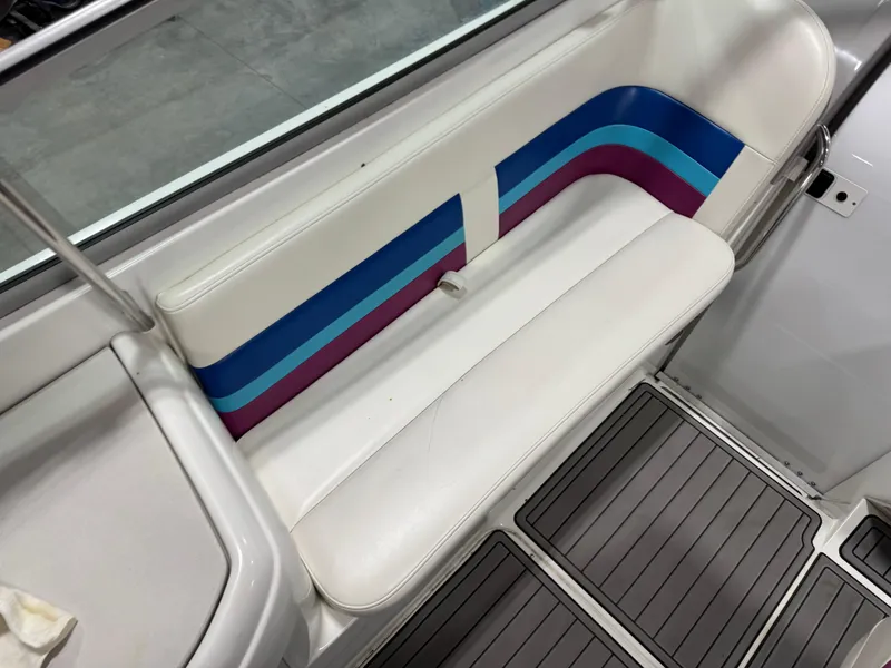 Slide: The Image of 1998 Formula 330 SS boat interior with white, blue, and purple seating. - 9