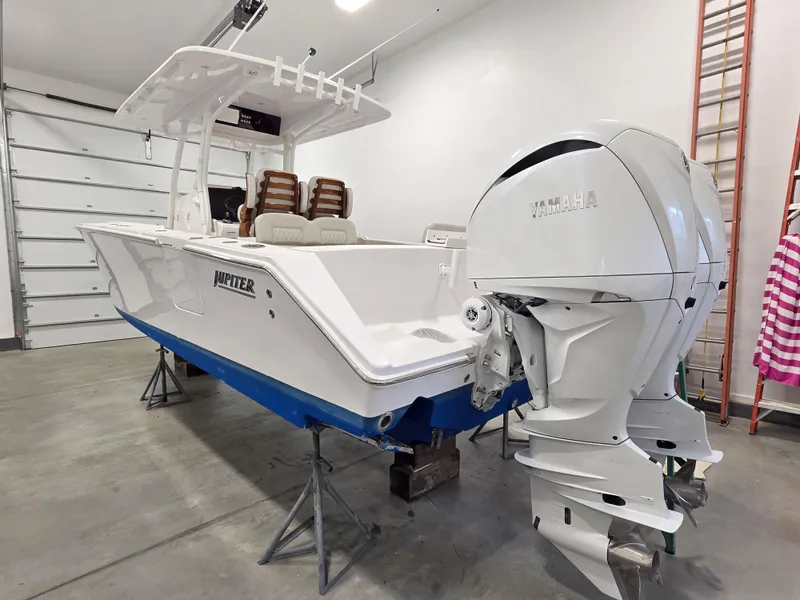 Slide: The Image of 2023 Jupiter 30 boat with Yamaha engine in a garage setting. - 1