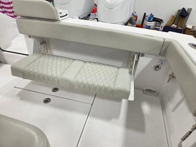 Slide: The Image of Jupiter 30 boat, 2023 model, featuring a foldable white cushioned seat with diamond stitching. - 10