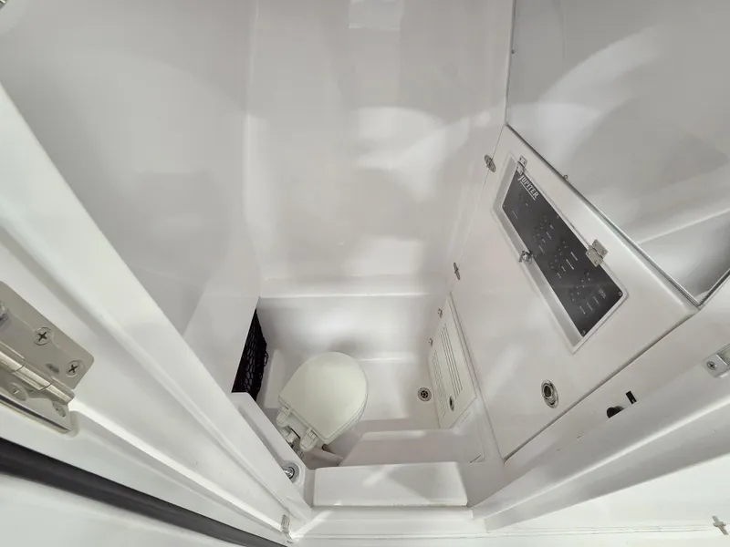 Slide: The Image of Compact bathroom in 2023 Jupiter 30 model, featuring a toilet and storage compartment. - 16