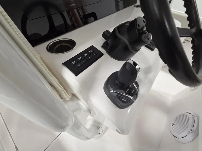 Slide: The Image of 2023 Jupiter 30 boat helm with steering wheel, control panel, and joystick. - 8