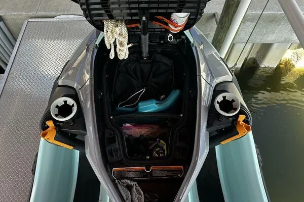 Slide: The Image of 2022 Sea-Doo Wake Pro 230 storage compartment with accessories and ropes. - 11