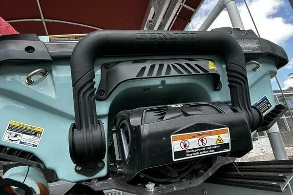 Slide: The Image of 2022 Sea-Doo Wake Pro 230 rear view, showcasing handle and warning labels. - 14