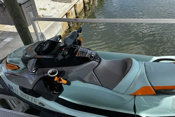 Slide: The Image of 2022 Sea-Doo Wake Pro 230 jet ski docked by the water. - 3