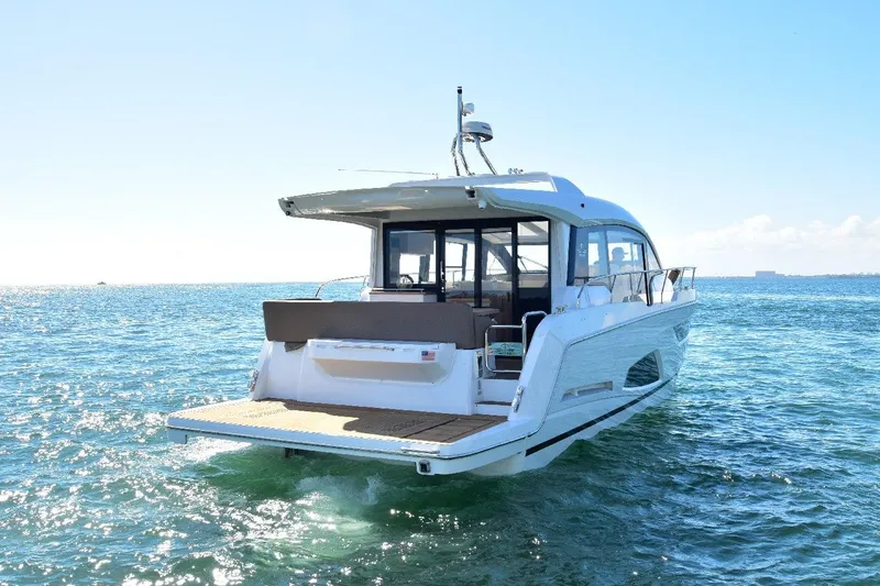 Slide: The Image of 2022 Sealine C430 #42 yacht cruising on open water under clear blue skies. - 14