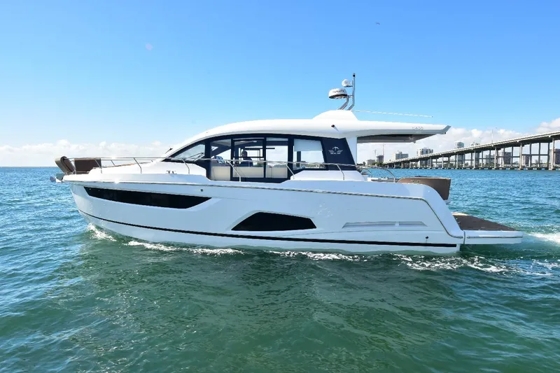 Slide: The Image of 2022 Sealine C430 #42 yacht cruising on open water under clear blue skies. - 16