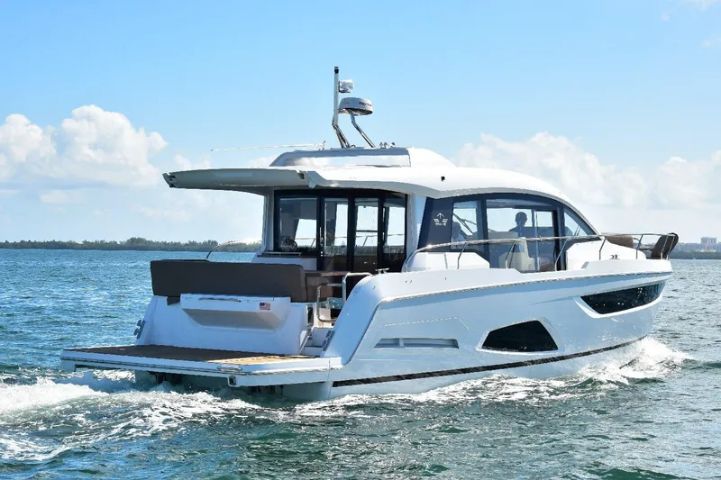 Slide: The Image of 2022 Sealine C430 #42 yacht cruising on open water under a clear blue sky. - 39