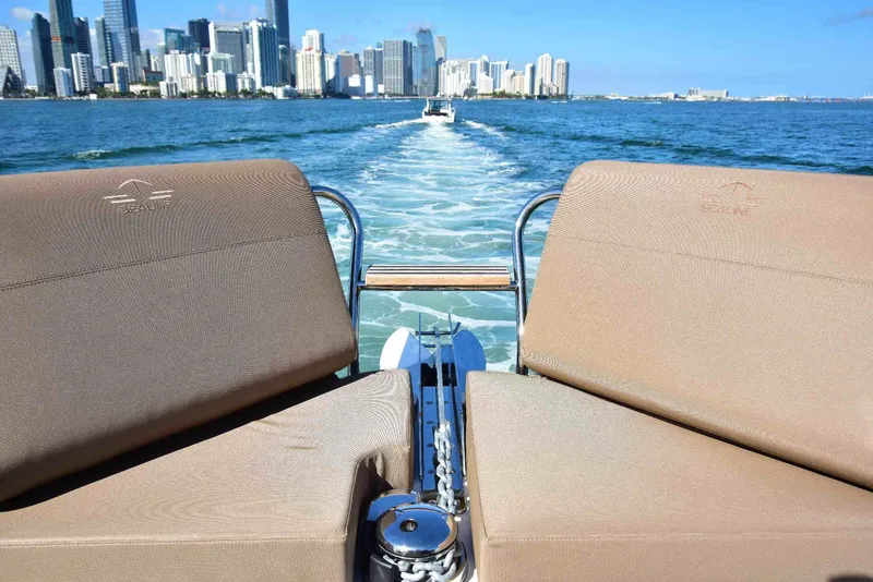 Slide: The Image of Sealine C430 #42 yacht cruising with city skyline in the background, 2022 model. - 42