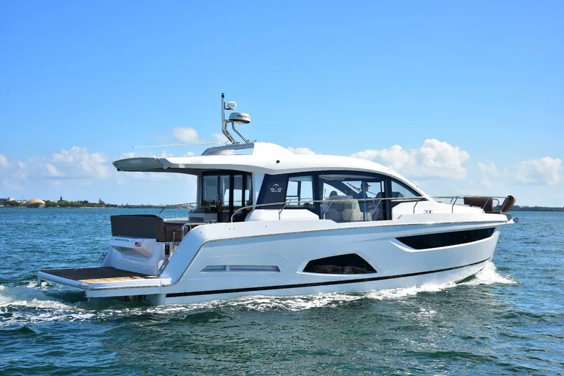 Slide: The Image of 2022 Sealine C430 #43 yacht cruising on open water under a clear blue sky. - 13