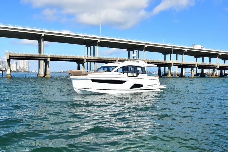 Slide: The Image of 2022 Sealine C430 yacht cruising under a bridge on a sunny day. - 20