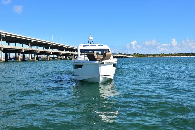 Slide: The Image of 2022 Sealine C430 yacht cruising near a bridge on a sunny day. - 21