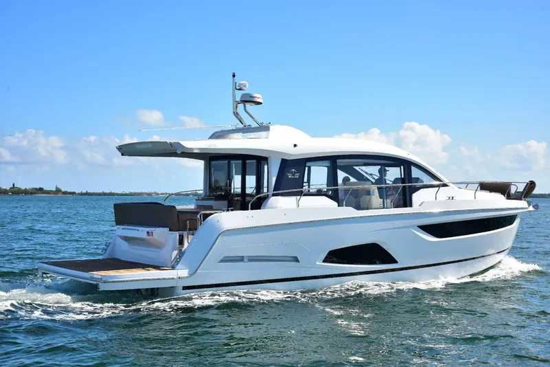 Slide: The Image of 2022 Sealine C430 yacht cruising on open water under a clear blue sky. - 34