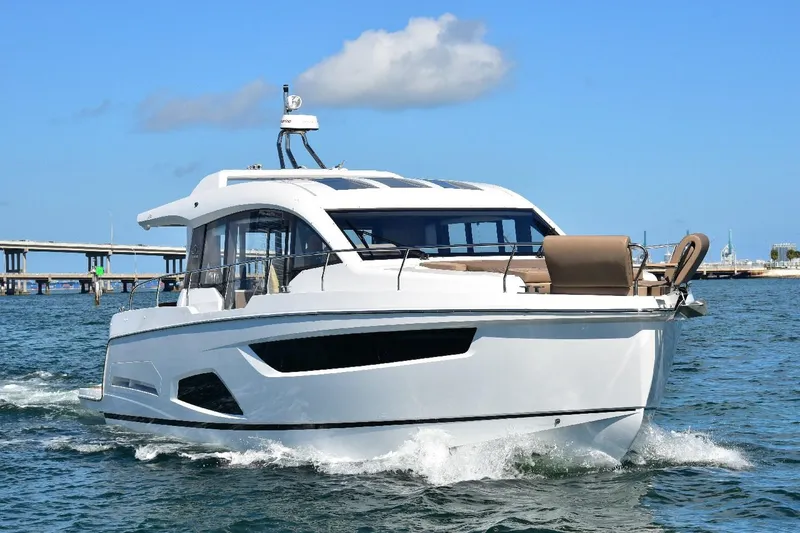 Slide: The Image of 2022 Sealine C430 yacht cruising on open water under clear blue sky. - 4