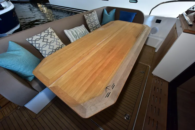 Slide: The Image of Luxurious seating area on 2022 Sealine C430 yacht with wooden table and decorative cushions. - 48