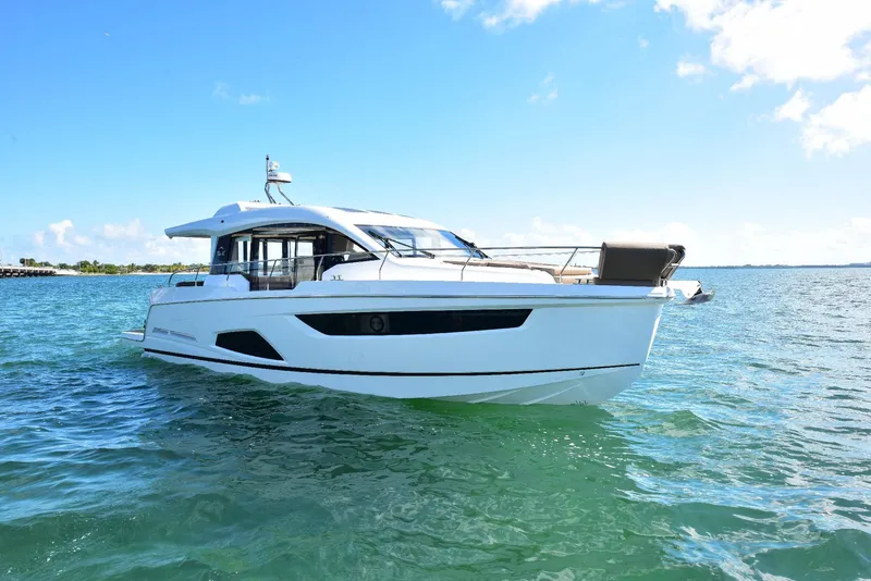 Slide: The Image of 2022 Sealine C430 yacht cruising on clear blue waters under a sunny sky. - 7