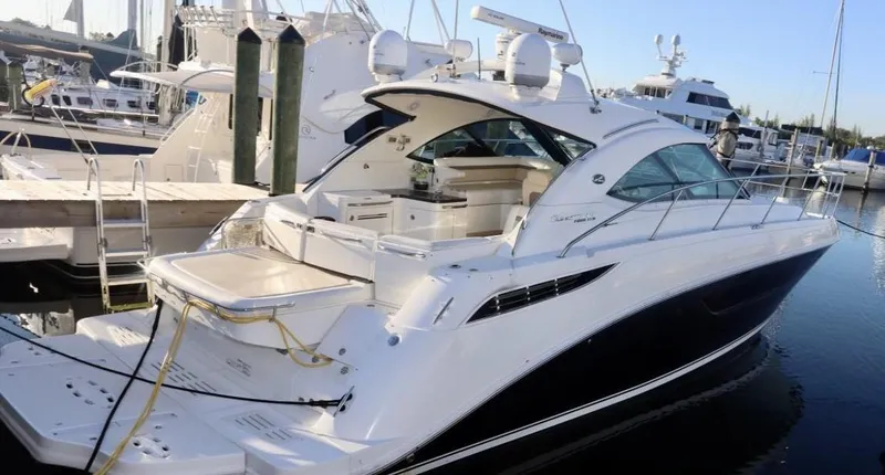 Slide: The Image of 2013 Sea Ray 410 Sundancer yacht docked at marina, sleek design, luxury features. - 1