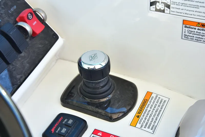 Slide: The Image of Control panel of 2013 Sea Ray 410 Sundancer boat with joystick and warning labels. - 38