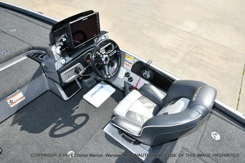 Slide: The Image of 2020 Nitro Z21 Pro boat cockpit with steering wheel, Lowrance electronics, and cushioned seat. - 44