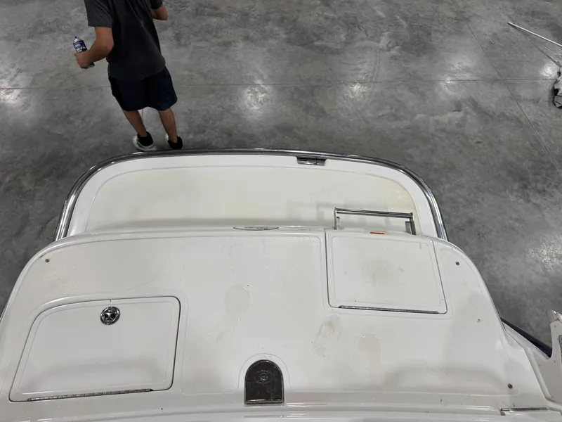 Slide: The Image of 2004 Cobalt 262 BR boat interior with a person standing nearby on a concrete floor. - 11