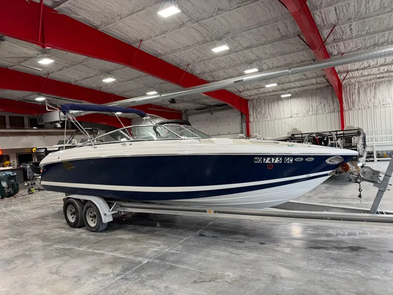 Slide: The Image of 2004 Cobalt 262 BR boat on trailer in spacious indoor storage facility. - 2