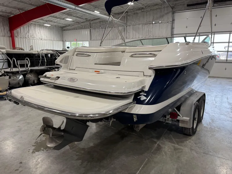 Slide: The Image of 2004 Cobalt 262 BR boat in a showroom, rear view with trailer. - 5