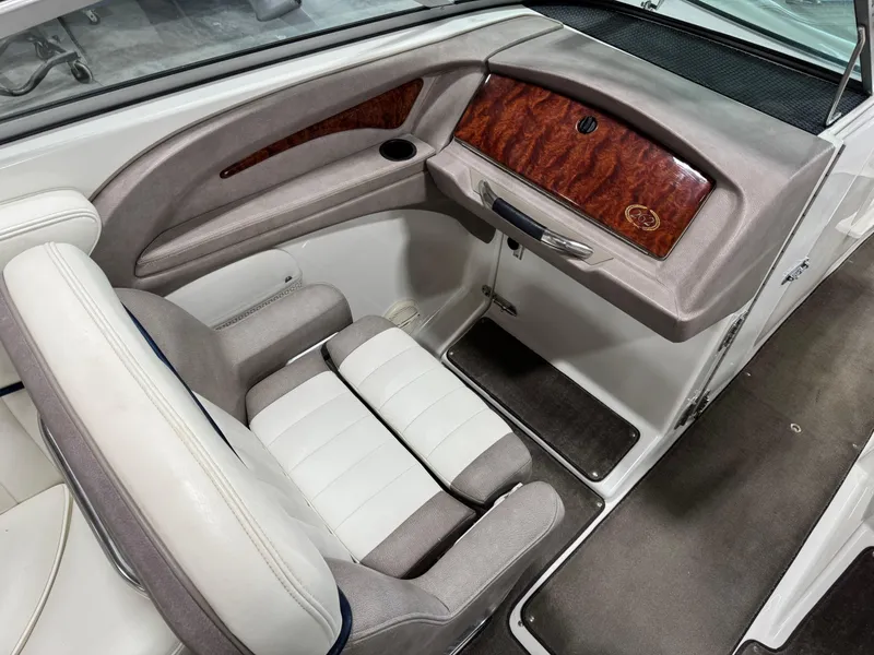 Slide: The Image of 2004 Cobalt 262 BR boat interior with plush seating and wood accents. - 8